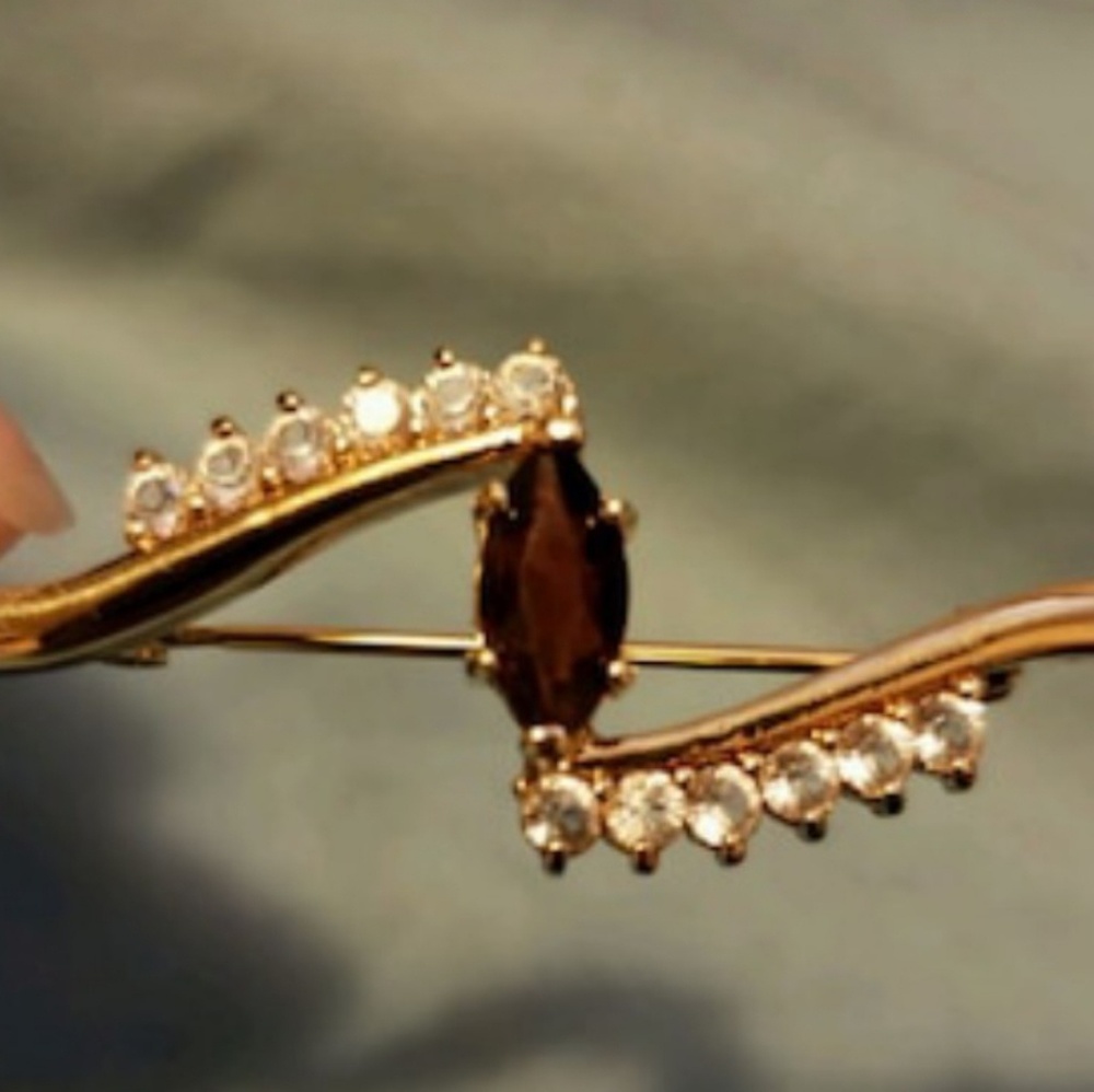 24k gold broohes.With diamonds and a ruby accent.
